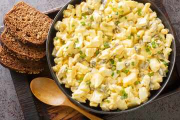 Eiersalat is a creamy German egg salad with cubes of crisp apple and crunchy sour pickles. closeup...