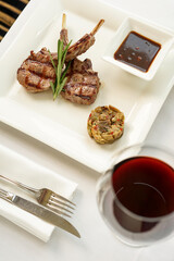 grilled meat square in a square plate with sauce, vertical photo
