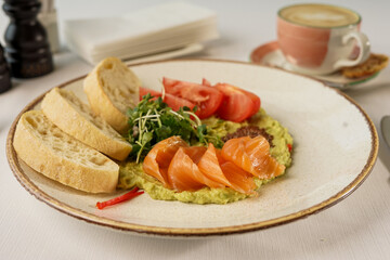 guacamole with shrimp and tomatoes in a plate with bruschetta

