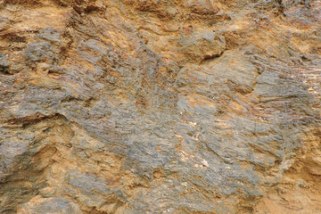 A brown and orange sedimentary rock containing sulfur and pyrite