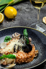 Risotto with seafood shrimp and mussels in shells, Food recipe background. Close up