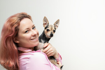 cute pet with owner,Happy woman with a small dog in her arms, copy space