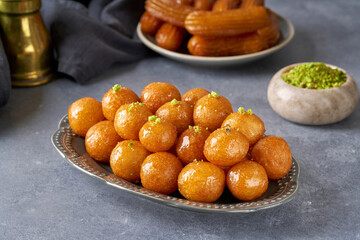 Traditional middle eastern  fried sweets lokma, awameh,  luqaimat. Ramadan dessert . Closeup