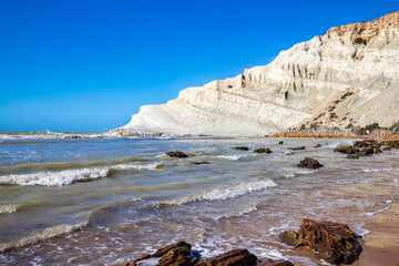 View of the limestone white cliffs with the beach at Stair of the Turks or Turkish Steps near Realmonte in Agrigento province. Sicily, Italy