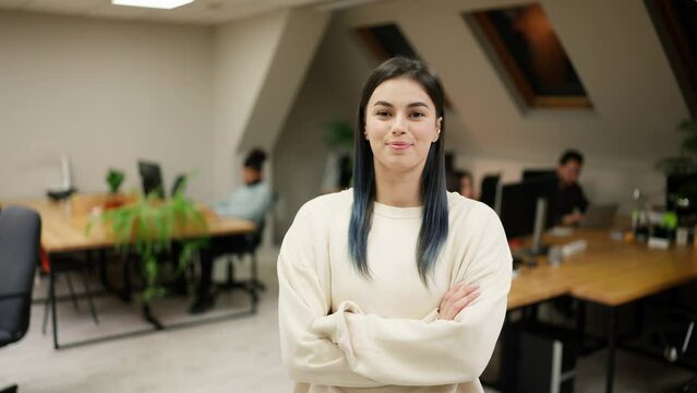Smiling modern girl standing at modern office coworking space