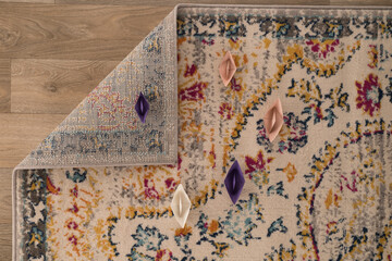 Specially designed carpet, laid on the floor and curled. Detail. White lace on a wooden background. 
