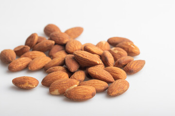 Heap of salted almonds on white background