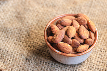 Roasted almonds in a ceramic cup.Warm tone image.