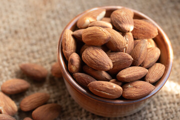 Roasted almonds in a ceramic cup.Warm tone image.