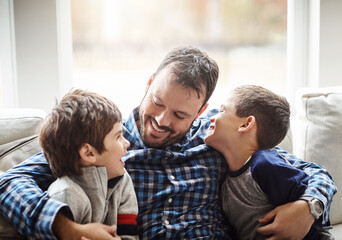 Family home, boys and dad with hug on sofa for conversation, love or bonding for childhood development. Happy people, relax or joke together in living room for fun, happiness or quality time in house - obrazy, fototapety, plakaty
