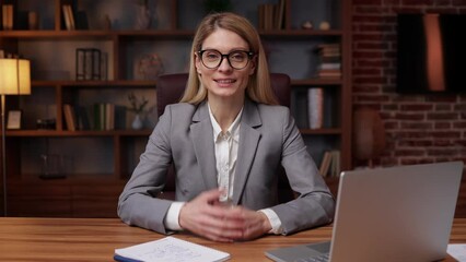 Friendly business woman talking at webcam making conference video call for job interview, business coach looking at camera recording vlog webinar, online training, e-coaching, consulting client online