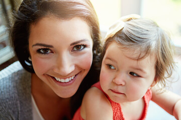 Happy, playful and portrait of a mother with a baby for bonding, quality time and relaxation. Smile, happiness and face of a mom playing with a child for care, comfort and carefree parenthood