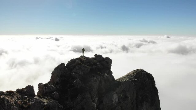 4K drone footage over woman arriving on a rocky peak overlooking breathtaking sea of clouds at La Maroma summit, Malaga, Spain.
Mid angle, parallax movement.