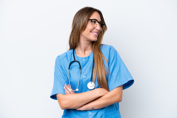 Young surgeon doctor woman isolated on blue background looking side