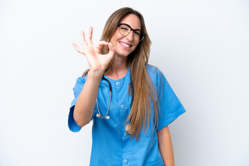 Fototapeta premium Young surgeon doctor woman isolated on blue background showing ok sign with fingers