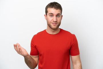 Young caucasian man isolated on white background making doubts gesture