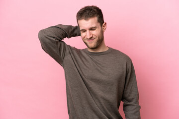 Obraz premium Young caucasian man isolated on pink background with neckache
