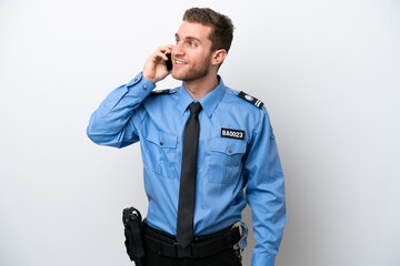 Young police caucasian man isolated on white background keeping a conversation with the mobile phone