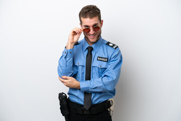 Fototapeta premium Young police caucasian man isolated on white background with glasses and happy