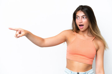 Young caucasian woman isolated on white background pointing away