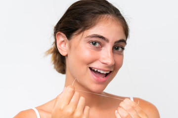 Young Pretty caucasian woman isolated on white background using dental floss with happy expression....
