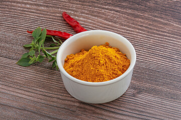 Yellow vibrant curcuma powder in the bowl