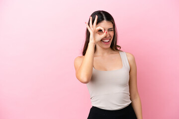 Young Italian woman isolated on pink background showing ok sign with fingers