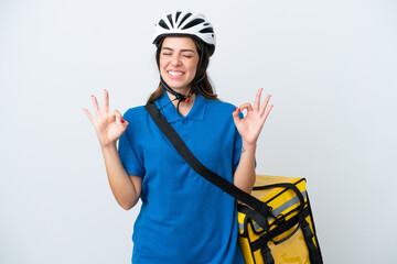 Young delivery woman with thermal backpack isolated on white background in zen pose