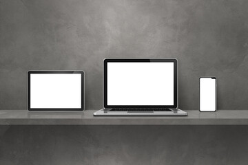 Laptop, mobile phone and digital tablet pc on grey wall shelf. Horizontal background