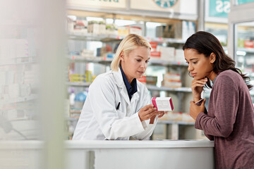 Consulting customer and focus of store pharmacist at counter for expert help and customer service. Pharmaceutical advice and opinion of worker helping girl with medicine information at pharmacy.