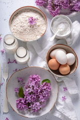 Ingredients for fried lilac flower in pancake dough.