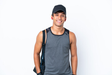 Young sport caucasian man with sport bag isolated on white background laughing