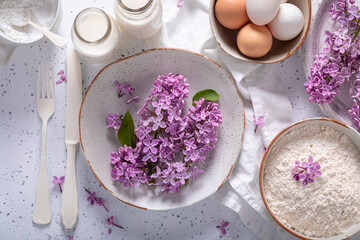 Obraz na płótnie Canvas Preparation for fried lilac flower with powdered sugar. Sweet dessert.