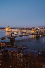 Night view of Budapest showcasing illuminated buildings, bridges, and reflections on the Danube River at dusk