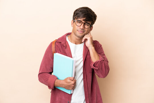 Young student caucasian man isolated on ocher background frustrated and covering ears