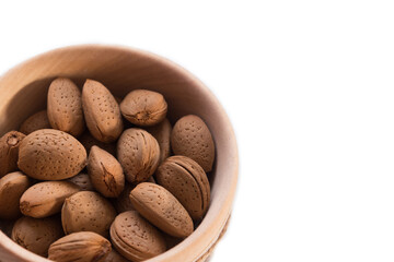 almonds in a wooden bowl on white isolated