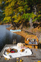 Picnic by the lake during autumn with vibrant foliage and a serene atmosphere
