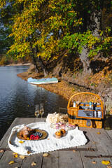 Picnic by the lake during autumn with vibrant foliage and a serene atmosphere