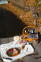 Picnic by the lake during autumn with vibrant foliage and a serene atmosphere