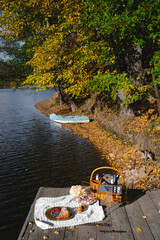 Picnic by the lake during autumn with vibrant foliage and a serene atmosphere