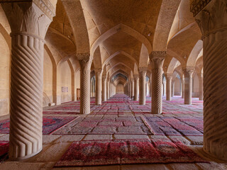 View of the gorgeous carved pillars of Vakil Mosque in Shiraz, Iran