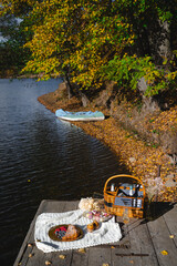 Picnic by the lake during autumn with vibrant foliage and a serene atmosphere