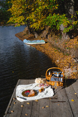 Picnic by the lake during autumn with vibrant foliage and a serene atmosphere