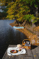 Picnic by the lake during autumn with vibrant foliage and a serene atmosphere