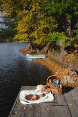 Picnic by the lake during autumn with vibrant foliage and a serene atmosphere