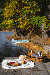 Picnic by the lake during autumn with vibrant foliage and a serene atmosphere