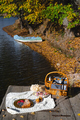 Picnic by the lake during autumn with vibrant foliage and a serene atmosphere