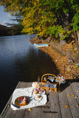Picnic by the lake during autumn with vibrant foliage and a serene atmosphere