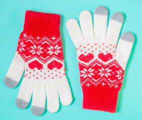 warm winter gloves on mint background.