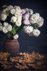 Autumn bouquet with garden flowers and autumn leaves